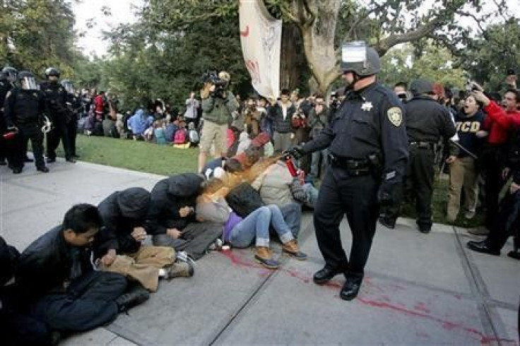 A University of California Davis police officer pepper-sprays students during their sit-in at an &#039;&#039;Occupy UCD&#039;&#039; demonstration in Davis, California November 18, 2011.