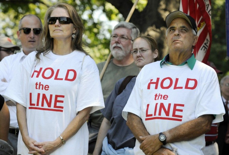 Tea Party supporters wear &quot;Hold the Line&quot; t-shirts as dozens rallied near the U.S. Capitol against raising the debt limit in Washington