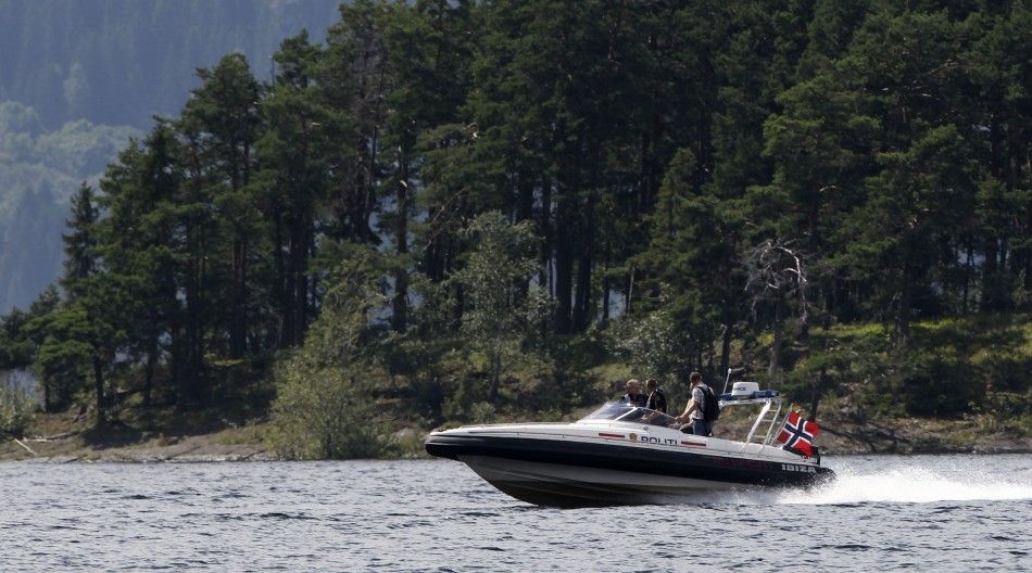 A police boat patrols a lake in front of the site of last Friday039s killing spree on Utoeya island northwest of Oslo