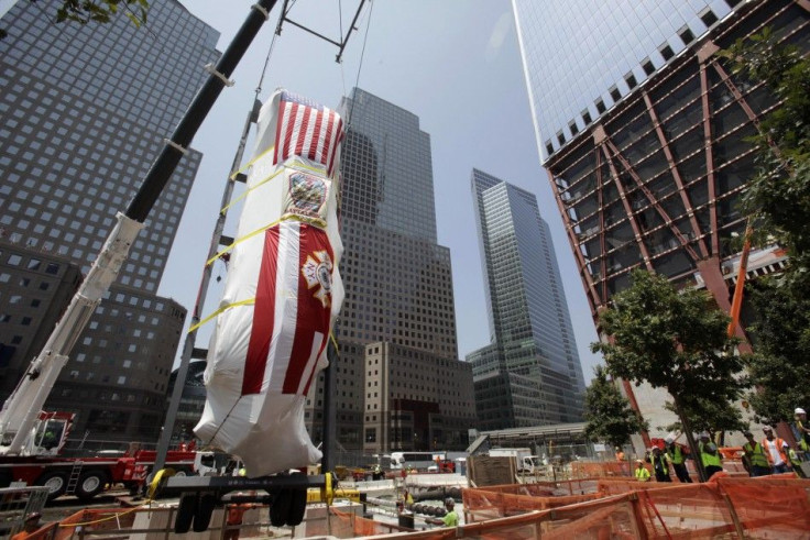 A Fire Department of New York Ladder Company 3 fire truck, which was partially destroyed in the September 11, 2001 attacks, is lowered into an opening in the World Trade Center site in New York