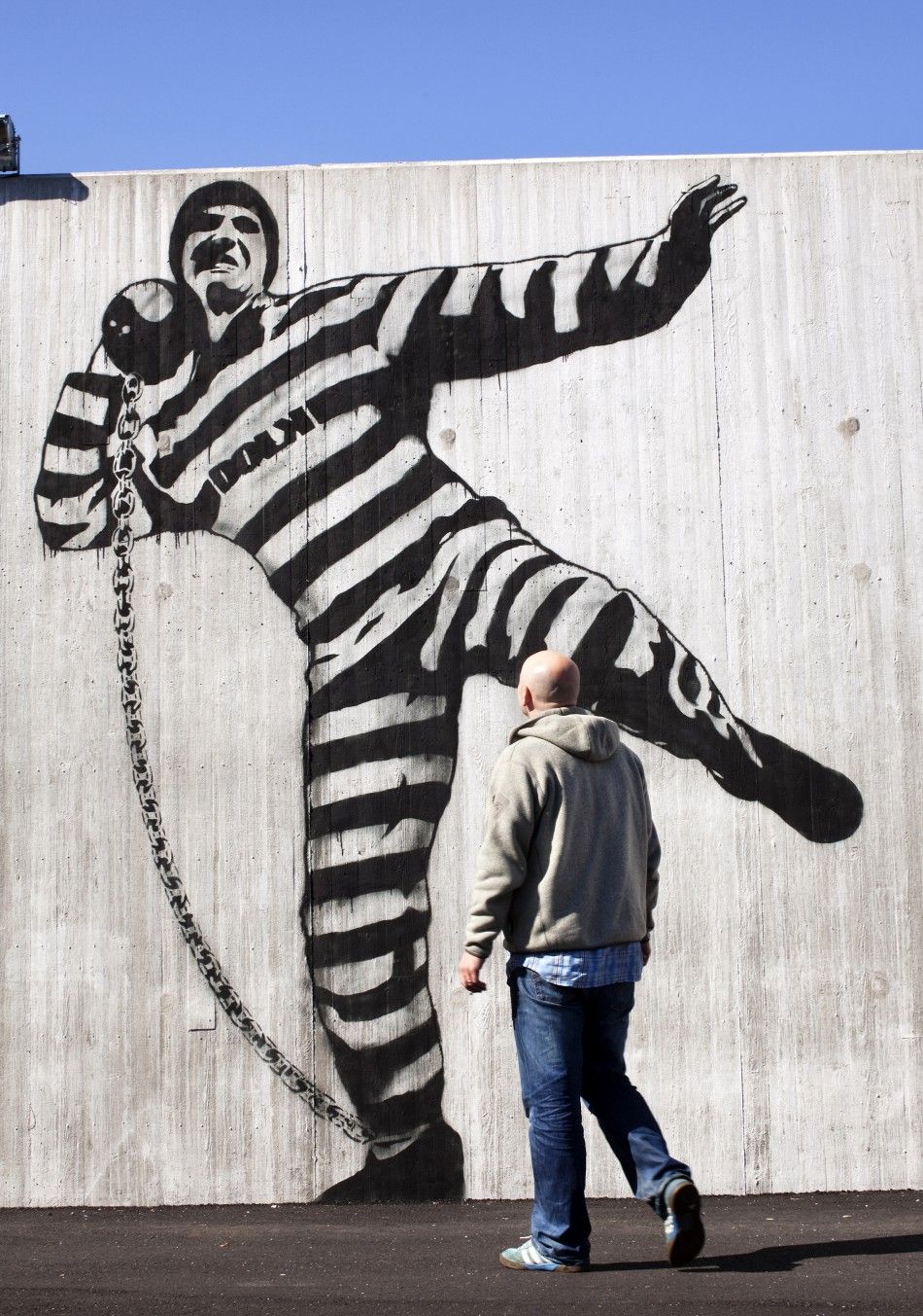 A man walks in front of graffiti inside Halden prison in the far southeast of Norway in this picture taken in 2010, released on July 27, 2011