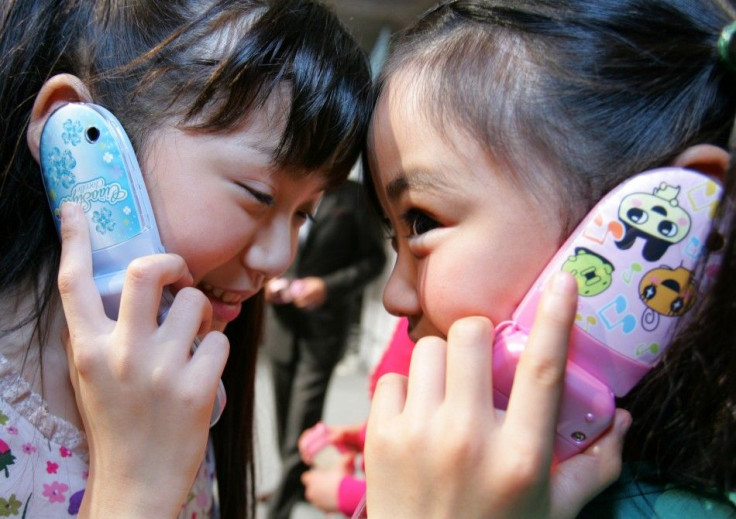 Children talking on their cell phones