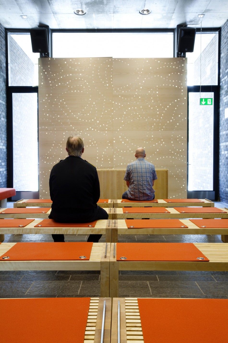 Two men sit inside the chapel at Halden prison in the far southeast of Norway in this picture taken in 2010
