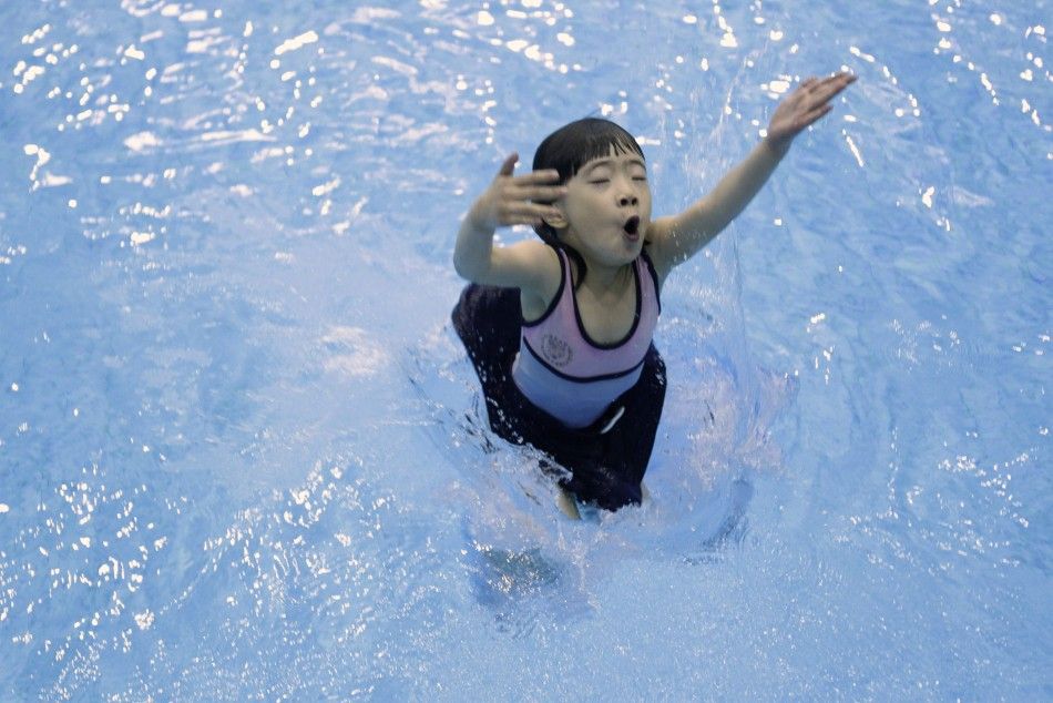 A 5-year-old girl practises during a diving training session at a training centre in Beijing