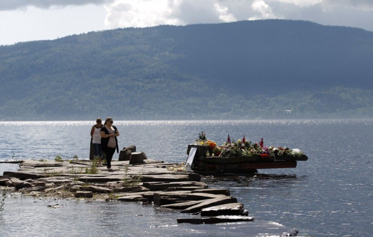 People pay their respects for victims in last Friday's killing spree and bomb attack, at temporary memorial site on shore in front of Utoeya island