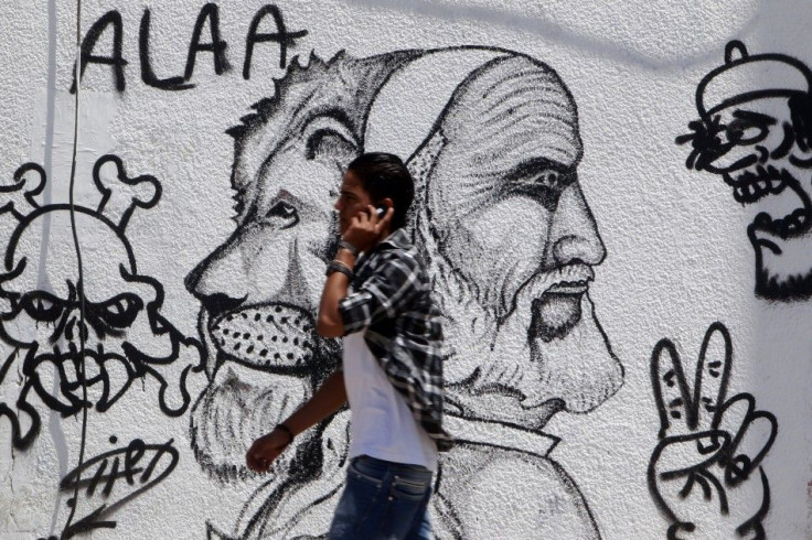A Libyan teen speaks in his mobile phone while walking.
