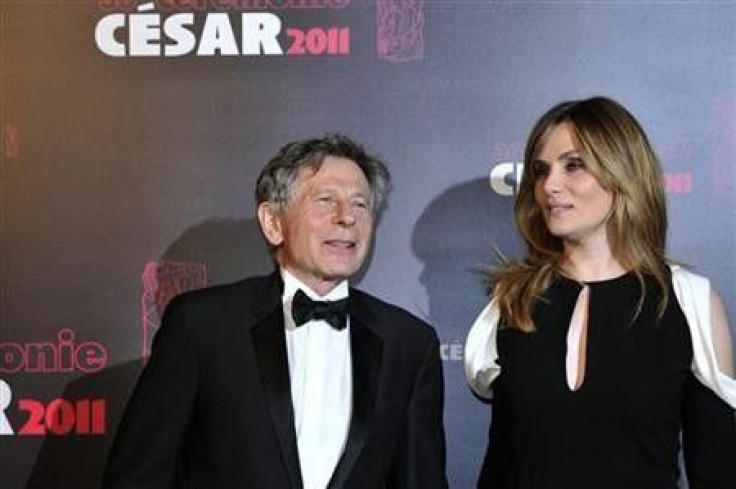 Film director Roman Polanski poses with his wife, French actress and singer Emmanuelle Seigner, as they arrive at the 36th Cesar Awards ceremony in Paris