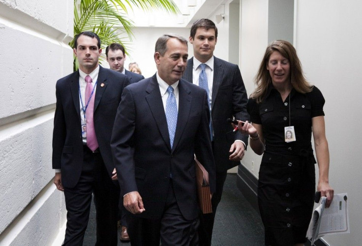 House Speaker John Boehner speaks with a reporter as he departs the Republican caucus meeting on Capitol Hill in Washington 28/07/2011