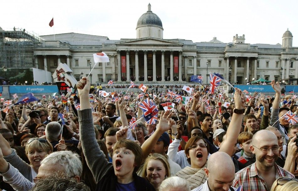 Spectators celebrate during the London 2012 Olympic Games one year countdown at an Olympic event in Trafalgar Square in London 