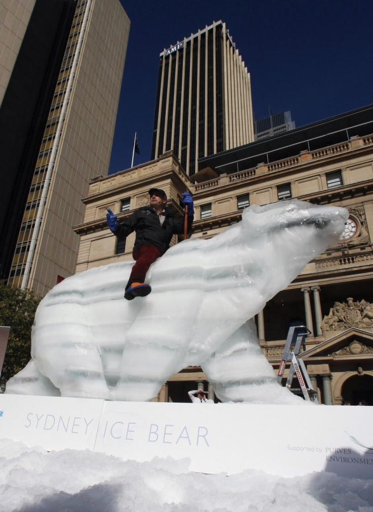 Coreth rides his life size ice polar bear in Circular Quay in central Sydney