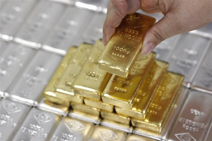 An employee picks up a gold bar at the Austrian Gold and Silver Separating Plant 'Oegussa' in Vienna