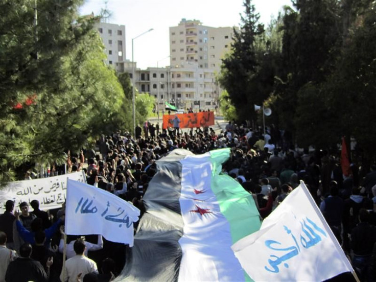 Demonstrators march against Syria&#039;s President Bashar al-Assad in Deir Balaba near Homs
