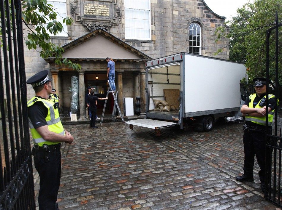 Police stand guard as preparations get underway for the wedding of Zara Phillips and Mike Tindall, at the entrance to the Canonngate Kirk in Edinburgh, Scotland July 28, 2011. The Queens grandaughter Phillips will marry England rugby player Tindall at th