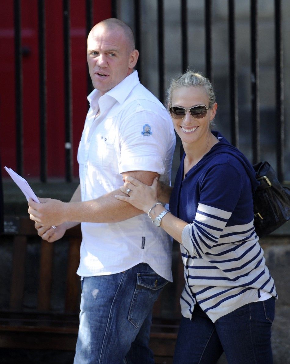 Britains Zara Phillips R, the eldest granddaughter of Queen Elizabeth and England rugby captain Mike Tindall L leave after their wedding rehearsal, at Canongate Kirk in Edinburgh, Scotland 