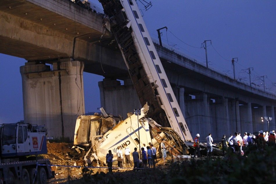 Rescuers carry out rescue operations after two carriages from a bullet train derailed and fell off a bridge in Wenzhou, Zhejiang province