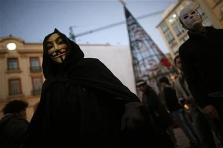 WikiLeaks supporters wear masks during a demonstration in Malaga