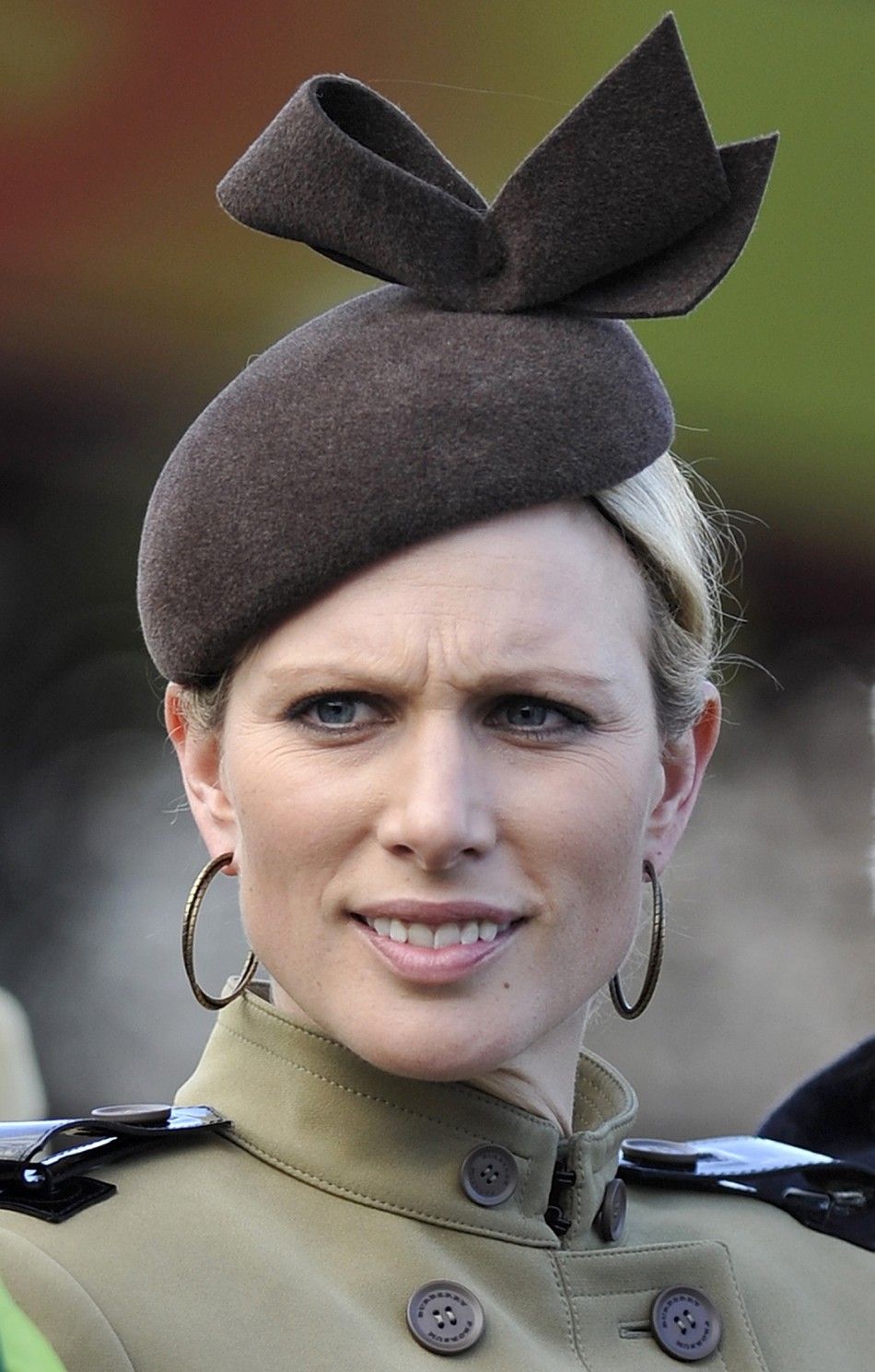 Britains Zara Phillips smiles as she chats with friends in the parade ring after the Gold Cup race at the Cheltenham Festival horse racing meet in England