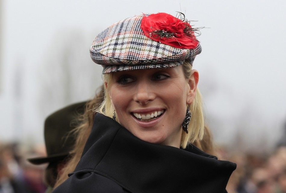 Britains Zara Phillips smiles as she walks through the unsaddling enclosure during the Cheltenham Festival horse racing meet in Gloucestershire