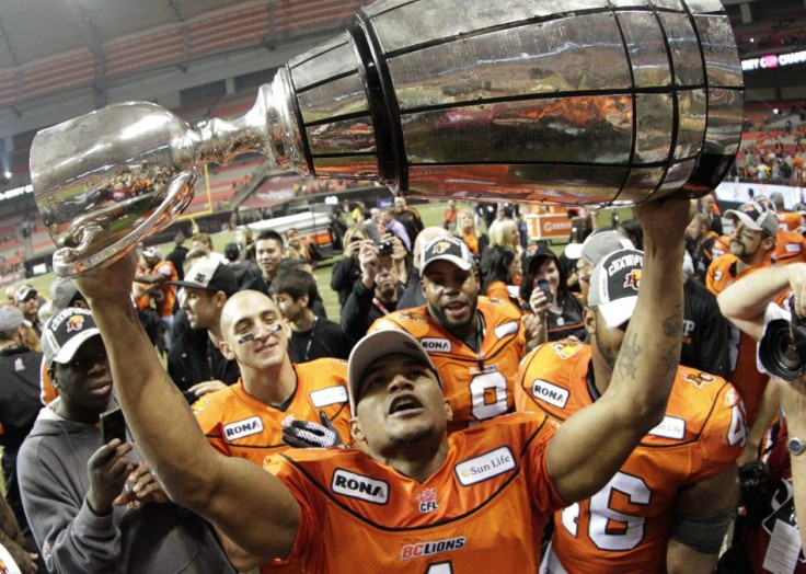 BC Lions wide receiver Bruce holds the Grey Cup after the Lions defeated the Winnipeg Blue Bombers to win the CFL&#039;s 99th Grey Cup football game in Vancouver