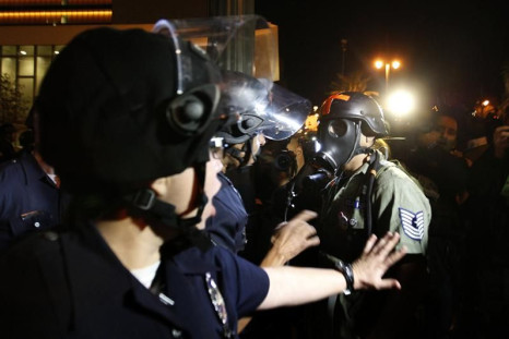 Police clear the street of protesters near the Occupy Los Angeles encampment at City Hall Park after the midnight deadline for eviction from City Hall Park passes in Los Angeles