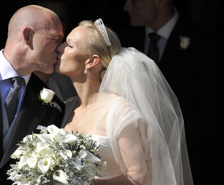 Britains Zara Phillips kisses her husband Mike Tindall after their marriage at Canongate Kirk in Edinburgh