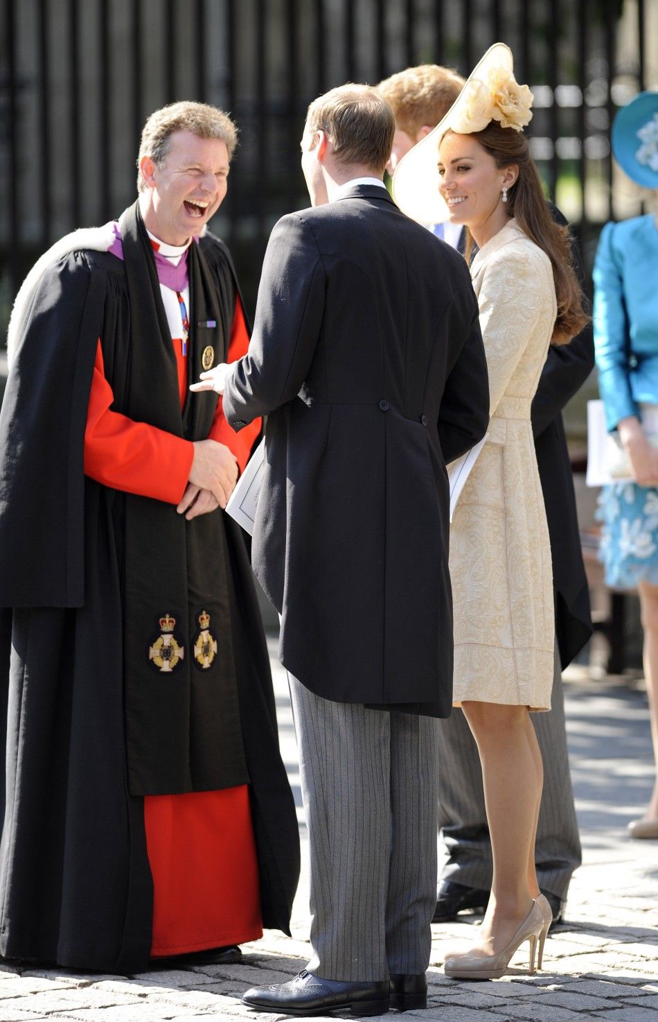 Britains Prince William, his wife Catherine and Prince Harry talk to The Reverend Neil Gardner in Edinburgh