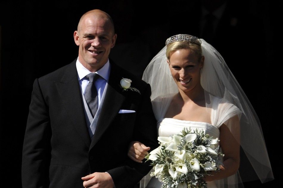 Britains Zara Phillips poses for a photograph with her husband Mike Tindall after their marriage at Canongate Kirk in Edinburgh