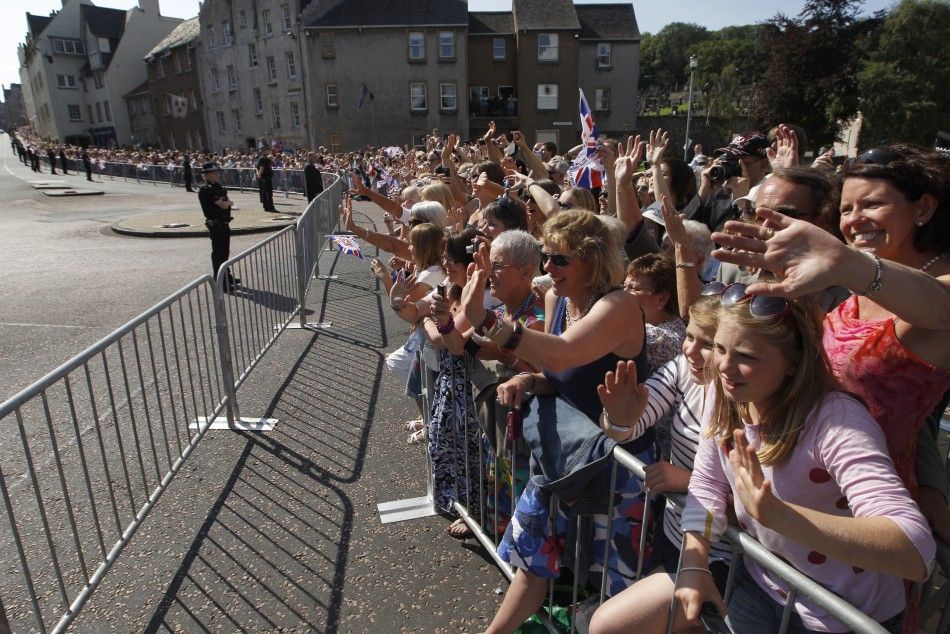 Spectators wave after the marriage between Zara Phillips and Mike Tindall at Canongate Kirk in Edinburgh