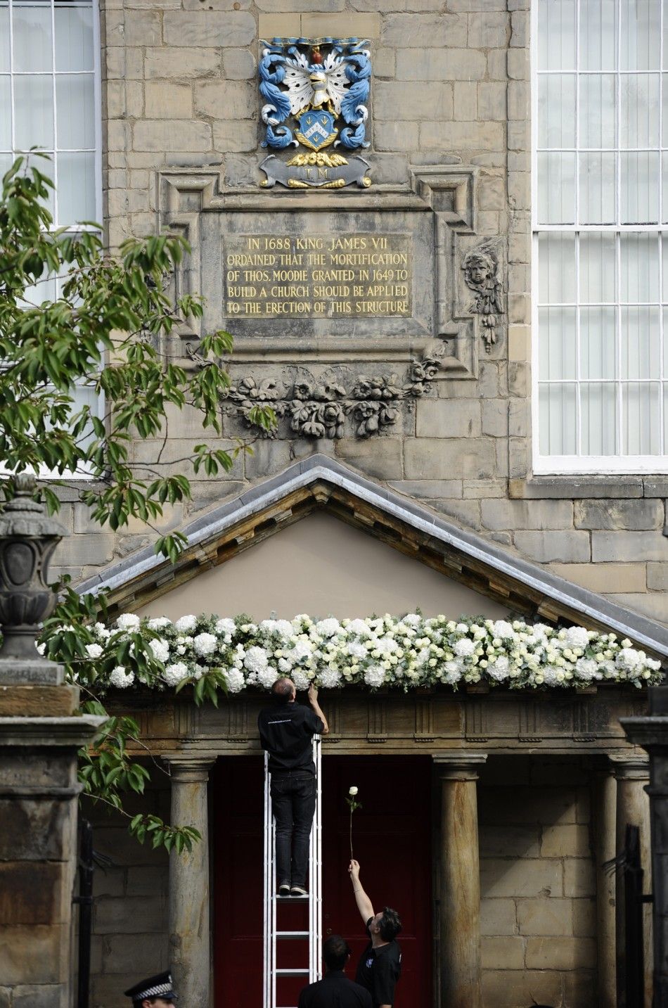 Workers put the finishing touches to Canongate Kirk before the marriage of Britains Zara Phillips and Mike Tindall in Edinburgh