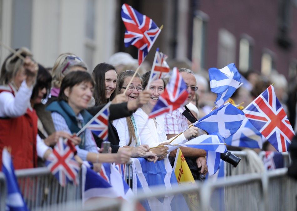  Spectators wave flags before the marriage between Britains Zara Phillips and Mike Tindall in Edinburgh