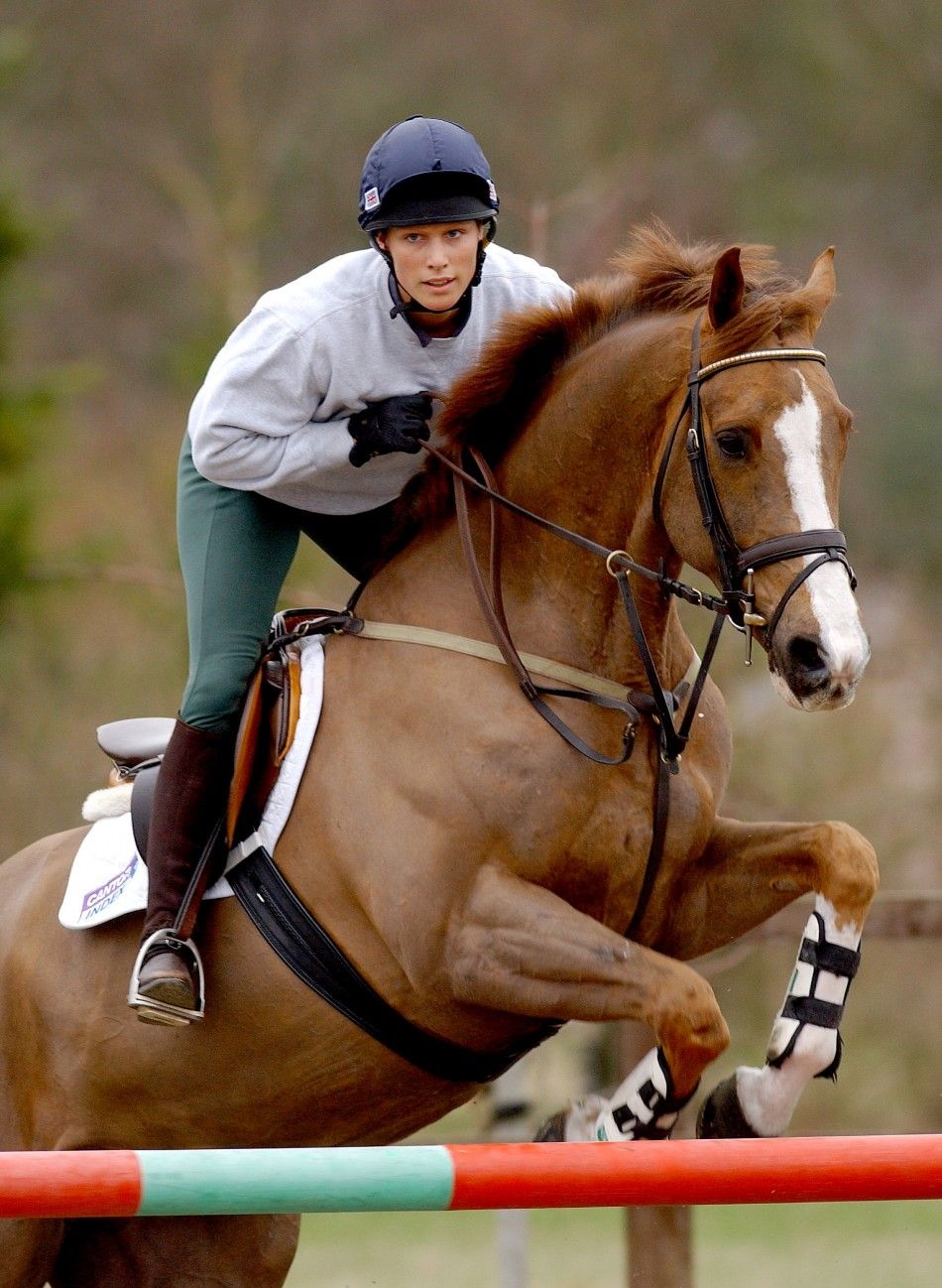 British Olympic hopeful Zara Phillips, the granddaughter of Britains Queen Elizabeth II, jumps as she rides Ardfield Magic Star during a training session at Waresley Park Stud Farm, in southern England, February 11, 2004. Phillips is aiming to be selec