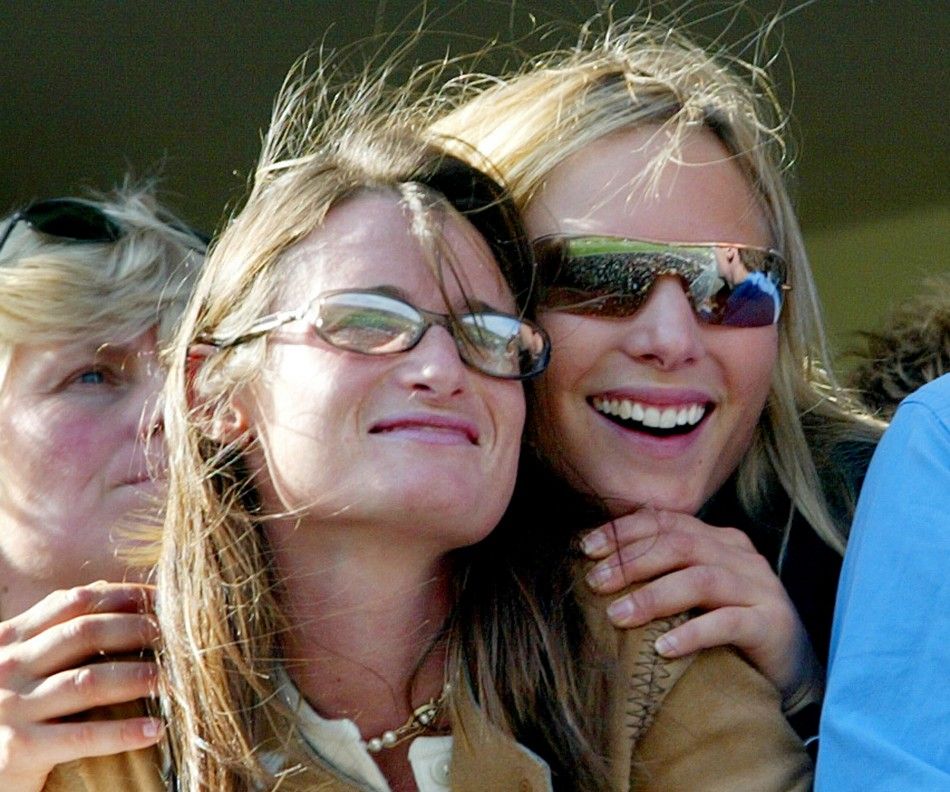 Britains Zara Phillips R watches the first race with a friend during the Cheltenham National Hunt Festival meeting