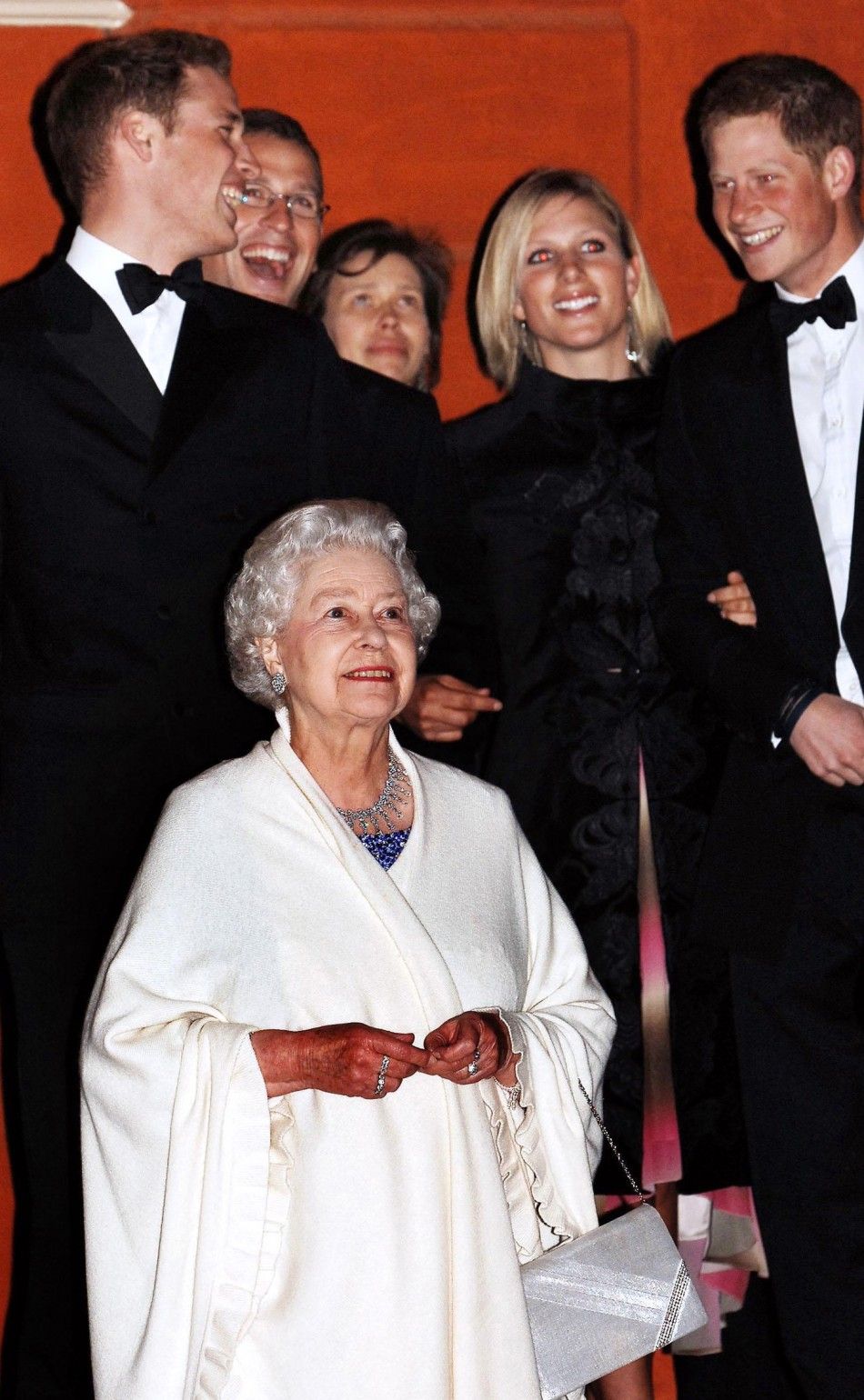 Britains Queen Elizabeth II stands to watch a firework display with four of her grandchildren