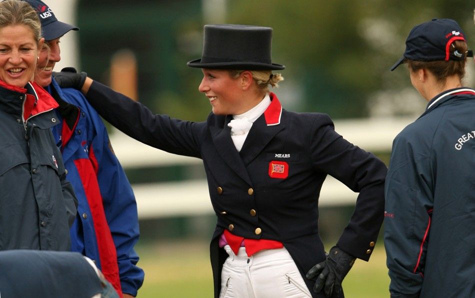 Britains Zara Phillips speaks with members of the British team after completing her test in the Eventing dressage competition at the World Equestrian Games in Aachen 