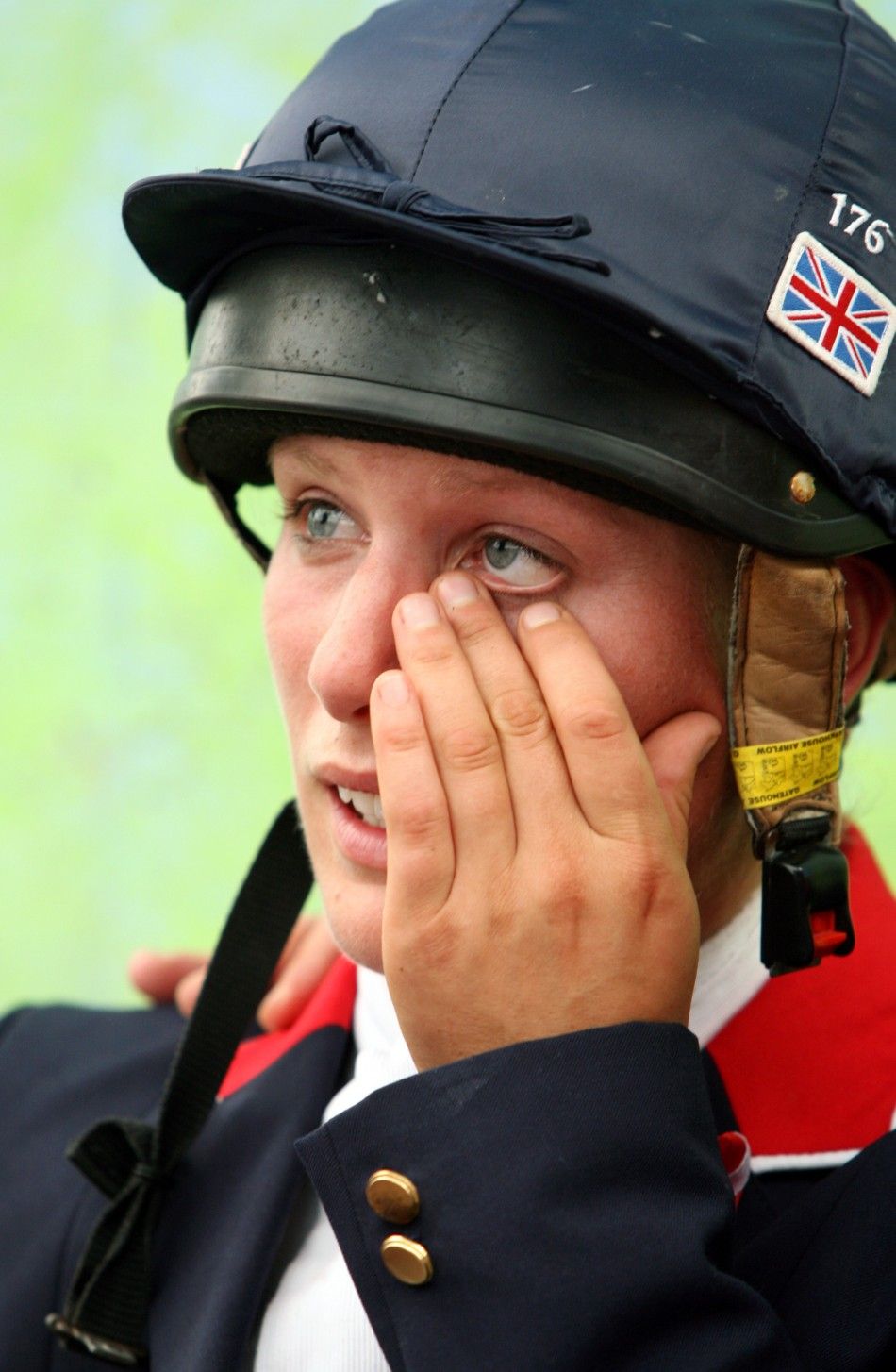 Britains Zara Phillips speaks with British team officials and team-mates after finishing her round in the show-jumping portion of the Eventing competition at the World Equestrian Games in Aachen