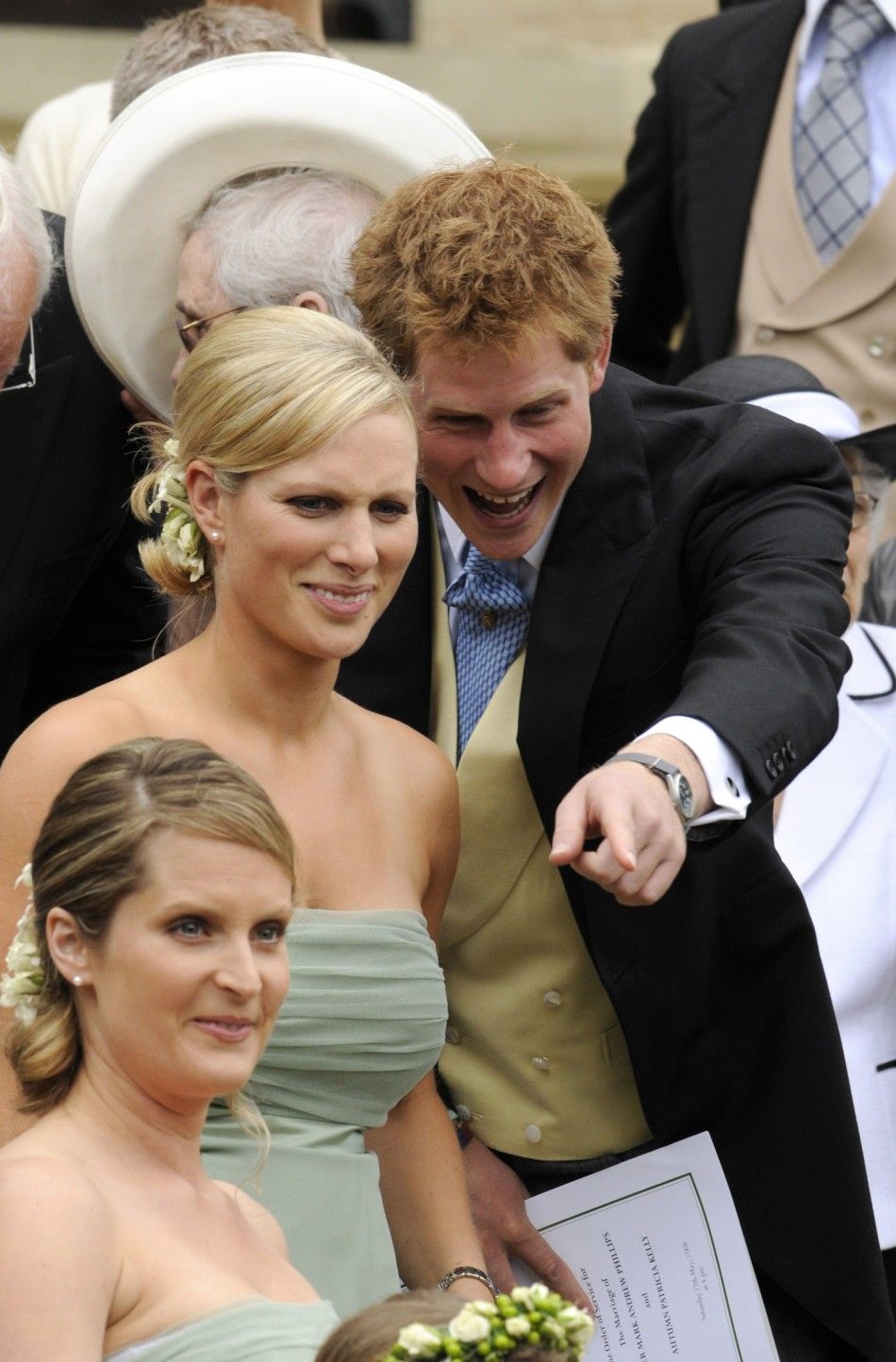 Britains Zara Phillips 2L and Prince Harry stand on the steps of St Georges Chapel after the marriage between Peter Phillips and Autumn Kelly, in Windsor, southern England 