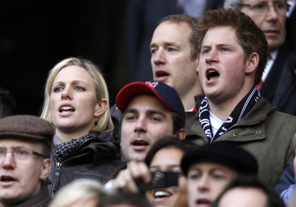 Prince Harry and Zara Phillips sing the national anthem as they stand in the crowd before a Six Nations rugby union match between England and France at Twickenham Stadium in west London