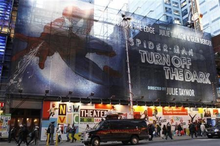 Pedestrians walk underneath a banner advertising the Broadway play &#039;&#039;Spiderman: Turn Off The Dark&#039;&#039; in New York December 23, 2010.