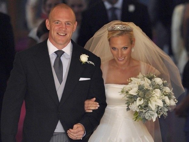 Britains Zara Phillips, the eldest granddaughter of Queen Elizabeth, and her husband England rugby captain Mike Tindall leave after their marriage at Canongate Kirk in Edinburgh, Scotland