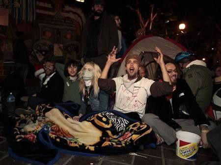 Protesters celebrate after they evaded eviction at the 12.01am deadline outside City Hall at the Occupy LA encampment in Los Angeles