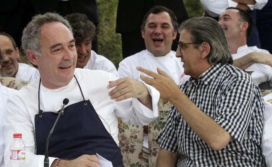 Ferran Adria, chef and co-owner of El Bulli restaurant, jokes with co-owner Juli Soler during a news conference in Cala Montjoi, near Roses.