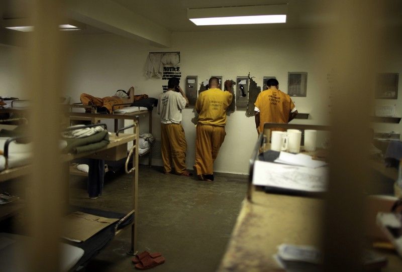 Inmates make phone calls from their cell at the Orange County jail in Santa Ana, California