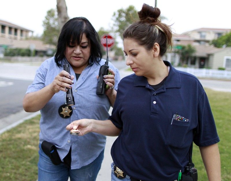 Orange County Deputy Probation Officer Erin Merritt R holds a spoon with black tar heroin 