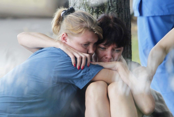 A woman is comforted by a Russian emergency ministry worker (L) on the banks of the Moscow river following a crash between a pleasure boat and barge in Moscow.