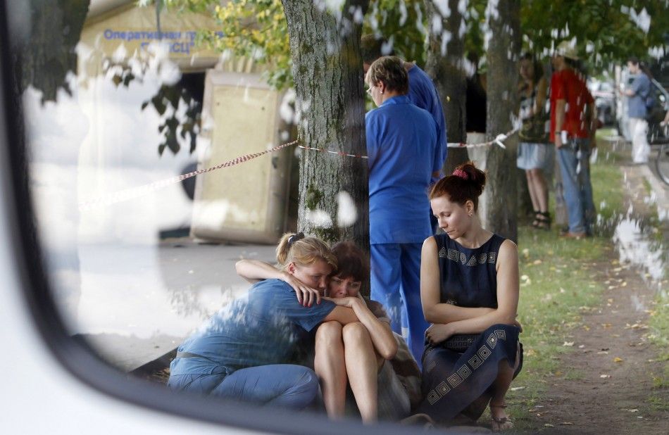 A woman is comforted by a Russian emergency ministry worker L on the banks of the Moscow river following a crash between a pleasure boat and barge in Moscow.