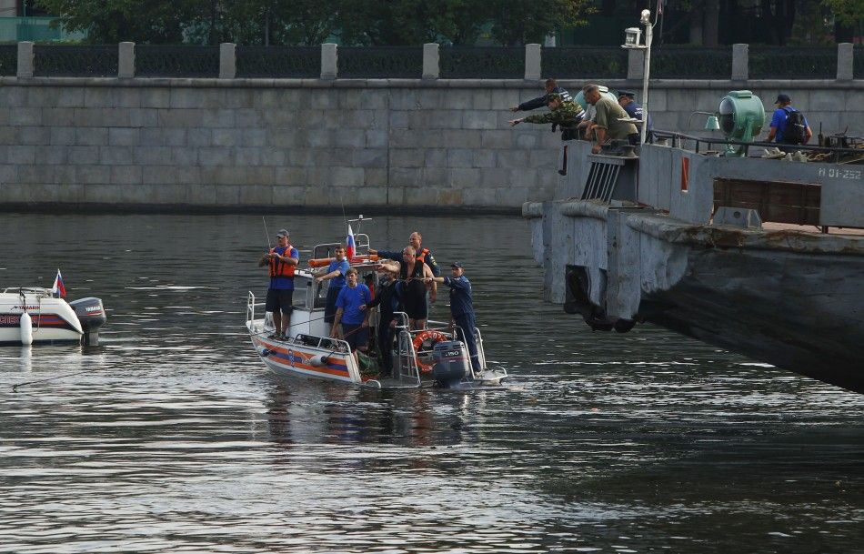 Emergency workers look for survivors following a crash between a private boat and river barge on the Moscow river in Moscow.