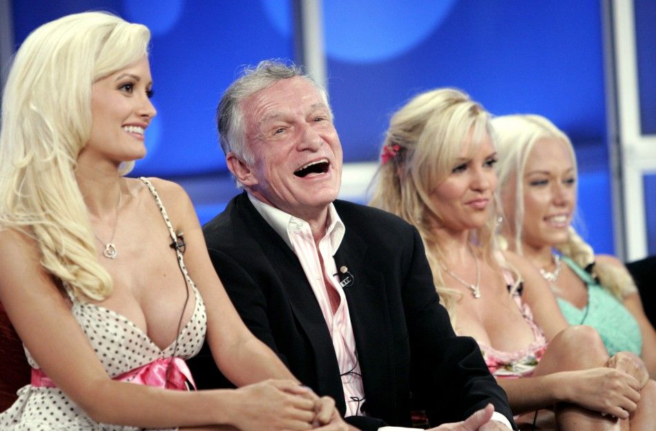 Playboy founder Hugh Hefner 2nd L, surrounded by his three girlfriends