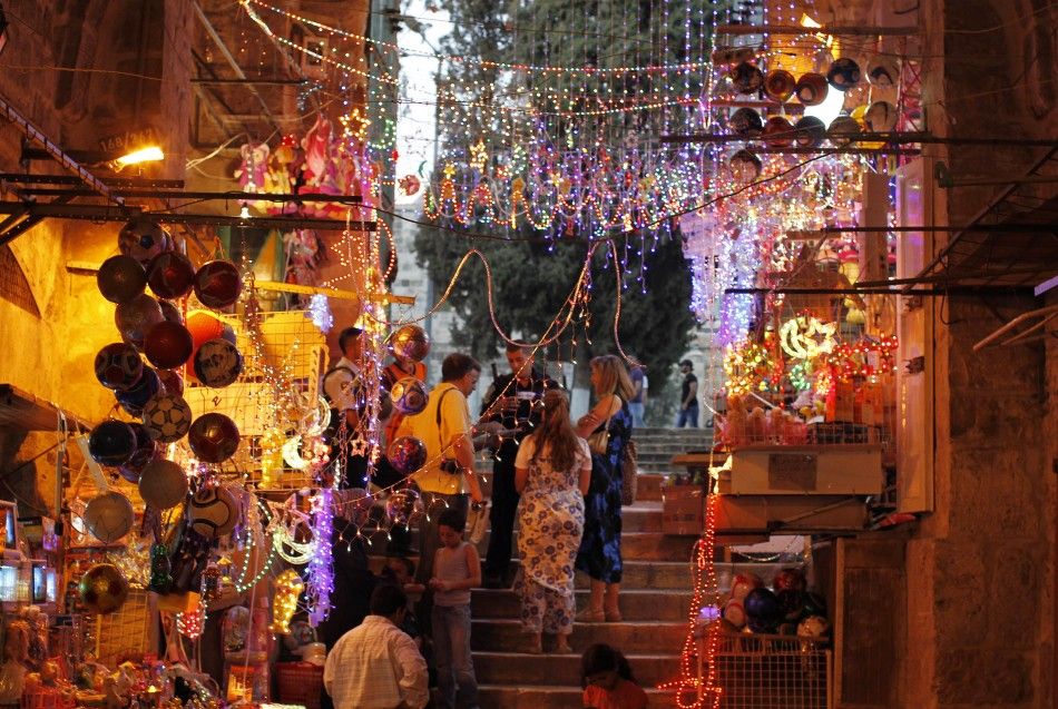 Tourists stand under decorations for Ramadan in Jerusalem039s Old City