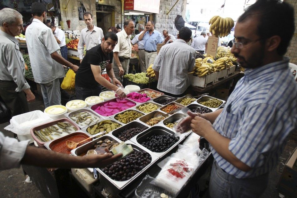 A man sells pickles ahead during a preparation for the Muslim holy month of Ramadan, at the downtown market area in Amman