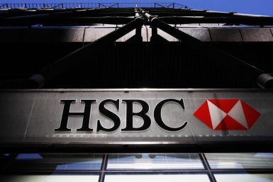 An HSBC bank logo is highlighted by the sun in London